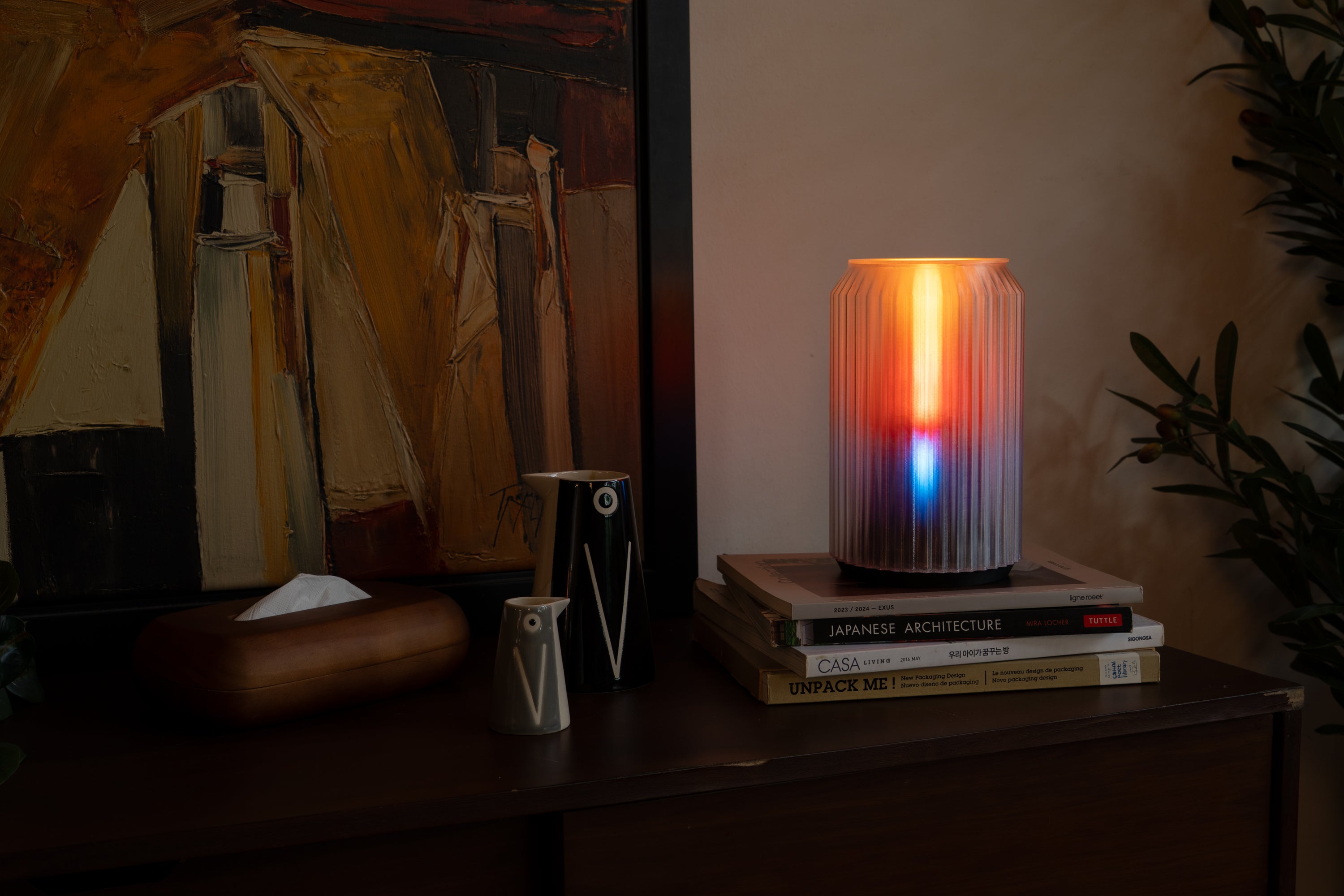 Ouro Gradial lamp glowing on a side table, a sculptural 3D printed light